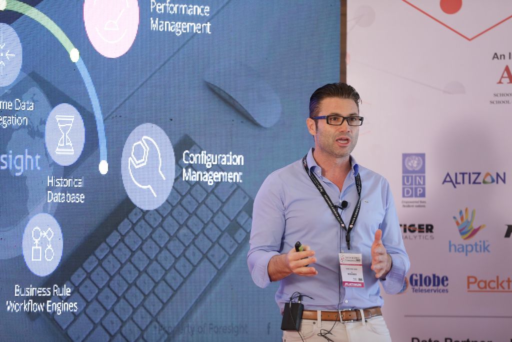 Speaker presenting technical session with data visuals